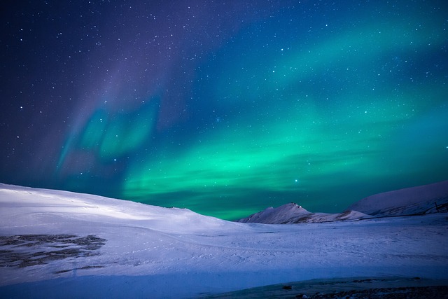 Aurora borealis over a frozen landscape, arctic experience