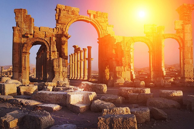 Ancient ruins silhouetted against a sunrise, evoking history